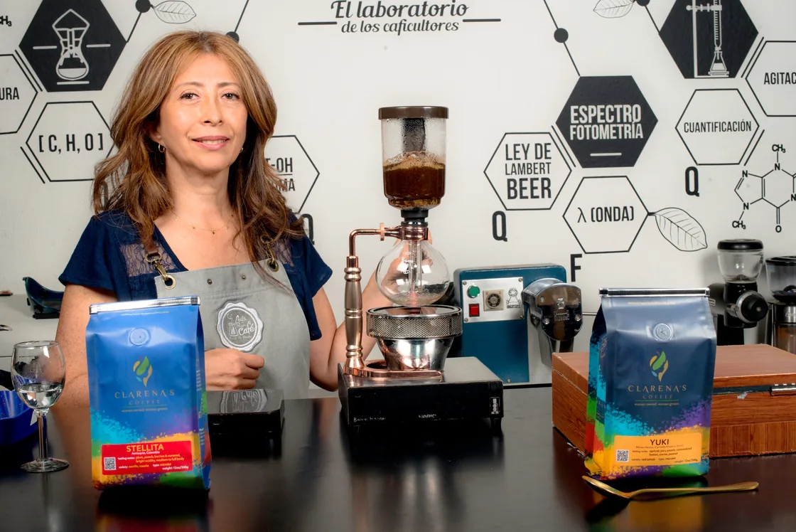 Founder Clarena McKinney holding a bag of Clarena’s Coffee in a coffee lab